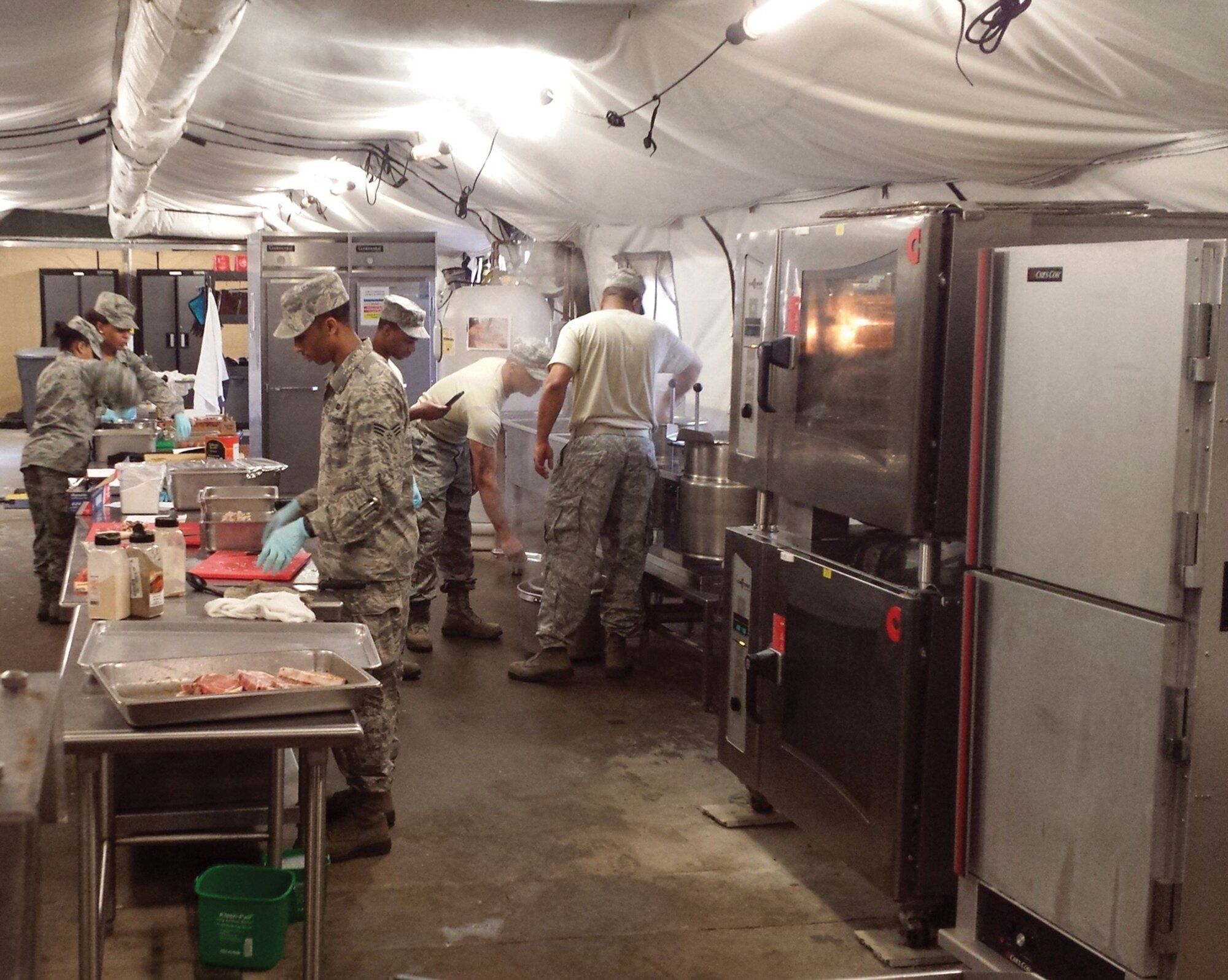 DOBBINS AIR RESERVE BASE, Ga. - The 445th services team prepares a Hispanic themed meal to serve 50 people within a time frame of 3 hours and 30 minutes. The team prepared Mexican pork chops and a chicken stew (El Pollo) along with a side dish plus dessert. (U.S. Air Force photo/Senior Master Sgt. Jim Highland)