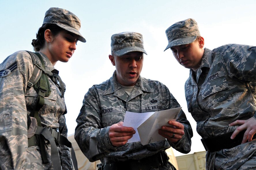 DOBBINS AIR RESERVE BASE, Ga. - Senior Airman Jessica McMillan, Tech. Sgt. Harold Debolt and Staff Sgt. Alison Barnes, 445th Force Support Squadron PERSCO team, review a clue for the scavenger hunt portion of the Readiness Challenge for Force Support Silver Flag at Dobbins Air Reserve Base, Georgia, March 12, 2015. Silver Flag participants had to race through numerous obstacles and puzzles during the portion on the challenge. (U.S. Air Force photo/Senior Airman Daniel Phelps)