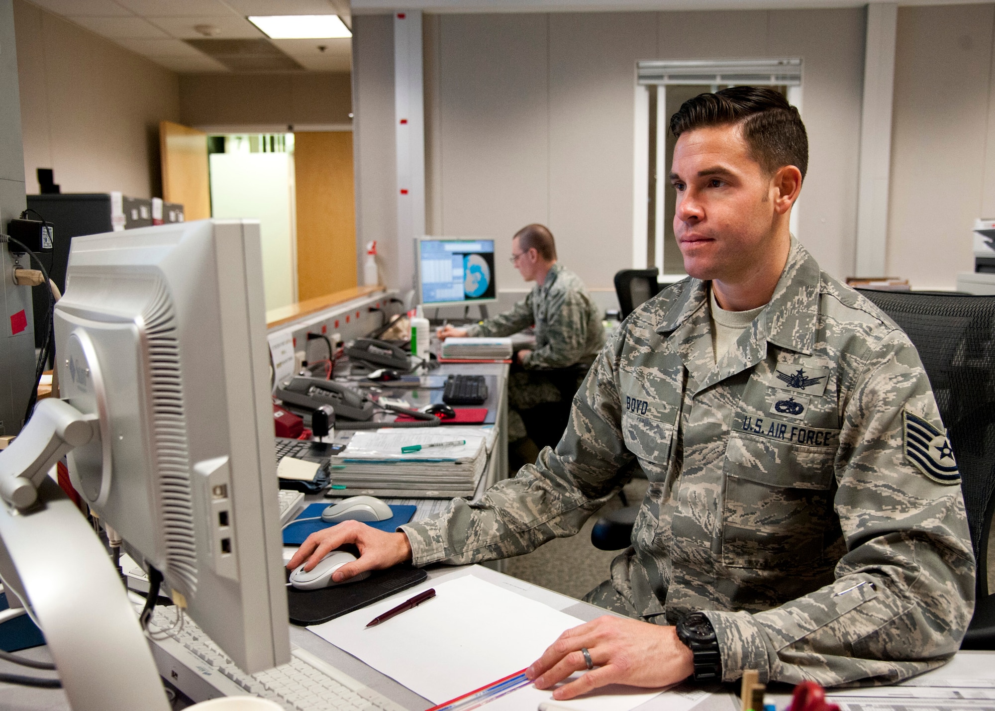 THULE AIR BASE, Greenland –Tech. Sgt. Christopher Boyd, 12th Space Warning Squadron NCO in charge operations support flight, performs various tasks assigned for the shift, March 25, 2015. The 12th SWS operates the Upgraded Early Warning Radar 24/7. The radar is maintained by U.S. and Canadian Airmen, and is assisted by a U.S., Danish and Greenlandic contractor force. (U.S. Air Force photo by Senior Airman Tiffany DeNault)