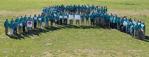 Personnel from Joint Base Langley-Eustis, Va., gather to form a ribbon for Sexual Assault Awareness Month and Sexual Assault Awareness and Prevention Month at Fort Eustis, Va., April 2, 2015. Civilians, U.S. Air Force Airmen and U.S. Army Soldiers walked and carried signs from the Post Exchange to Murphy Field where they gathered together to increase awareness of the observance month. (U.S. Air Force photo by Staff Sgt. Teresa J. Cleveland/Released)