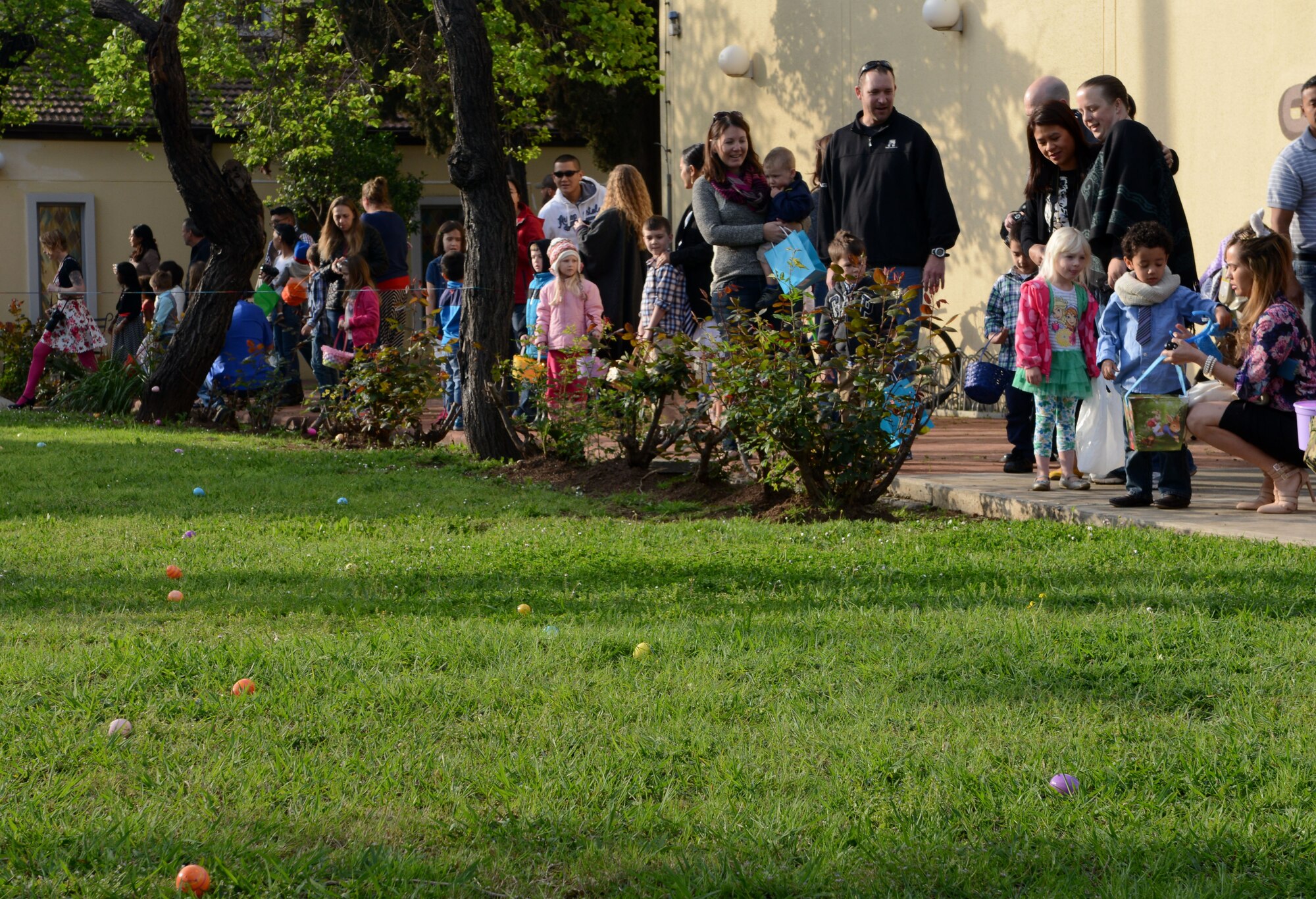 Families line up ready to search for Easter eggs April 5, 2015, at Incirlik Air Base, Turkey. The base chapel hosted the Easter egg hunt to help bring the Incirlik community together. (U.S. Air Force photo by Staff Sgt. Caleb Pierce/Released)
