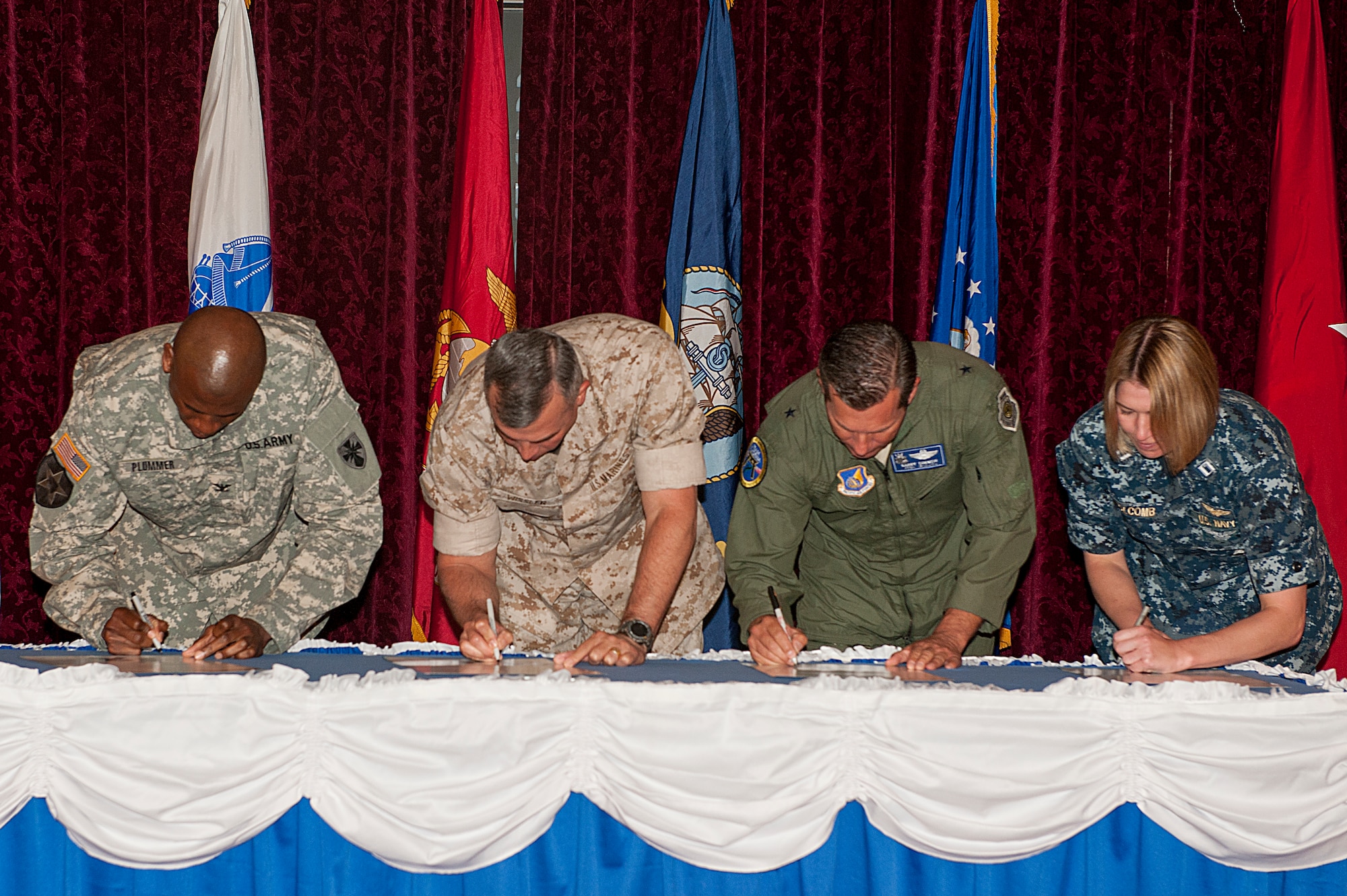 From left to right: U.S. Army Col. Leon Plummer, 10th Regional Support Group commander; U.S. Marine Corps Lt. Gen. John E. Wissler, 3rd Marine Expeditionary Force commanding general and Marine Forces Japan commander; U.S. Air Force Brig. Gen. Barry R. Cornish, 18th Wing commander; and U.S. Navy Lt. Julie Holcomb, U.S. Navy administrative officer for commander of Fleet Activities Okinawa; sign a proclamation to show their support of the Sexual Assault Prevention and Response mission at the Rocker NCO Club on Kadena Air Base, Japan, April 7, 2015. The proclamation officially declared April 2015 as Sexual Assault Awareness Month and encourages participation in efforts to prevent sexual assault, thereby strengthening the Armed Forces community. (U.S. Air Force Photo by Airman 1st Class Stephen G. Eigel)