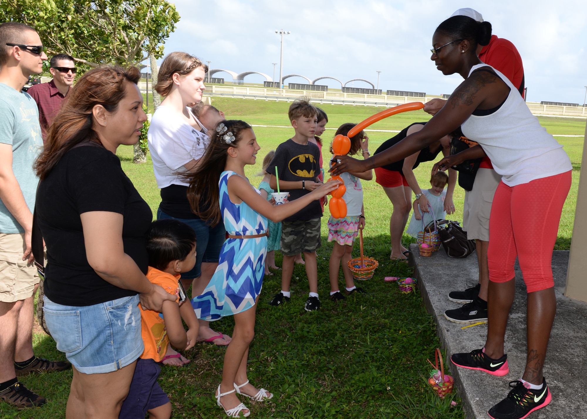 Staff Sgt. Mahawa Barber, 36th Mobility Response Squadron, gives a child a balloon during an Easter egg hunt April 4, 2015, at Andersen Air Force Base, Guam. The annual event included an egg hunt, games, face painting, food and other activities that drew more than 650 children. (U.S. Air Force photo by Senior Airman Cierra Presentado/Released)