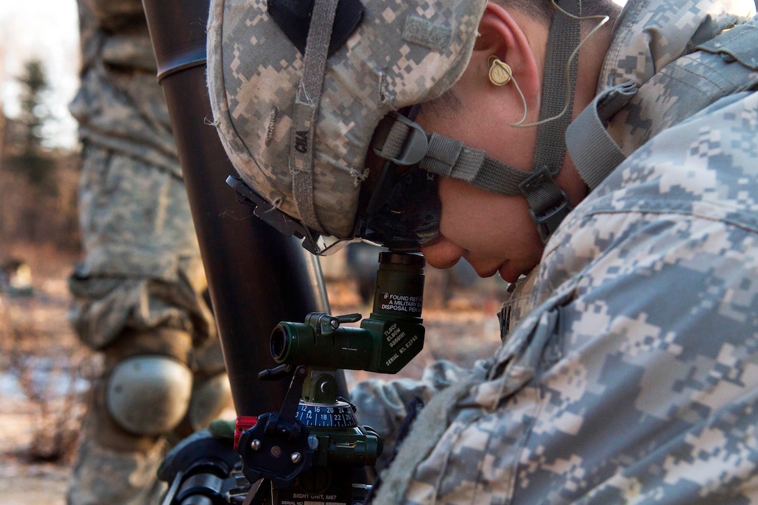 Army Spc. Kevin Cha calibrates an M121 120-mm mortar system during live-fire training on Joint Base Elmendorf-Richardson, Alaska, April 3, 2015. Cha is assigned to the 25th Infantry Division's 1st Battalion, 501st Infantry Regiment, 4th Infantry Brigade Combat Team, Alaska.