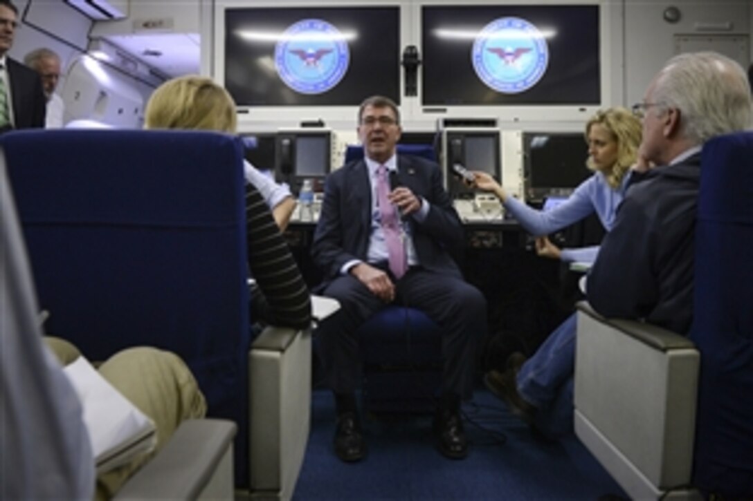 Defense Secretary Ash Carter briefs members of the press aboard an E-4B jet en route to Japan,  April 6, 2015. Carter is on a visit to the U.S. Pacific Command Area of Responsibility to make observations for the future force and the military's shift to the Pacific. 