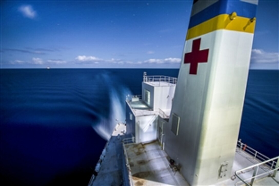 The Military Sealift Command hospital ship USNS Comfort transits the Atlantic Ocean at night, April 3, 2015, while  supporting Continuing Promise 2015. The operation shows U.S. support and commitment to Central and South America and the Caribbean. 