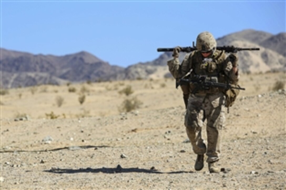 Marine Cpl. Joshua S. Baczkowski carries an M240B machine gun during a Marine Corps activity to test and evaluate on Marine Corps Air Ground Combat Center  in Twentynine Palms, Calif., March 30, 2015. Baczkowski is a machine gunner assigned to Weapons Company, Ground Combat Element Integrated Task Force.
