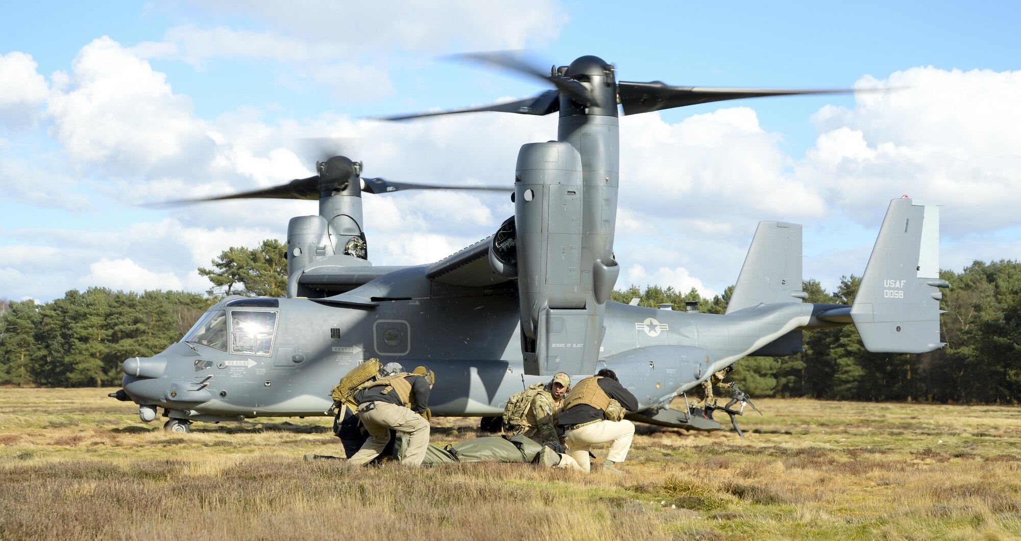 Members of the 352nd Special Operations Support Squadron Deployed Aircraft Ground Response Element assigned to RAF Mildenhall prepare to board a CV-22B Osprey during an exercise March 25, 2015, at Stanta Training Range near Thetford, England. DAGRE are highly-trained security forces Airmen who perform a wide range of special operations missions. (U.S. Air Force photo by Senior Airman Victoria H. Taylor)