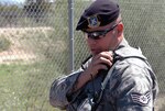 Staff Sgt. Abraham Pena, a security forces craftsman, radios information on a traffic violator to the security dispatcher. Pena returned to active duty with the wing in mid-July after serving nearly six months in Iraq.