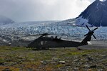 An Alaska Air National Guard HH-60 Pave Hawk helicopter waits five miles from the Knik Glacier crash site for the weather to clear before making another attempt to reach the survivors of a plane crash Aug. 8, 2010.