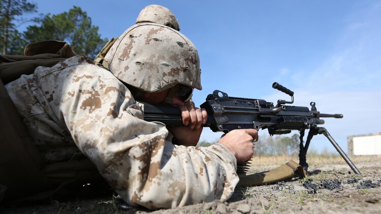 Private First Class Mitchell Coyle, a mortarman with Scout Sniper Platoon, 1st Battalion, 2nd Marine Regiment, fires an M249 Squad Automatic Weapon during the Table 1 Machine Gun Qualification aboard Camp Lejeune, April 6, 2015. The platoon executed a combined machine gun and sniper rifle range, with the Marines getting valuable experience on both weapon systems. Machine gunners play an integral role in the scout sniper platoons, and it is imperative each Marine in the platoon has a working understanding of how they operate. 