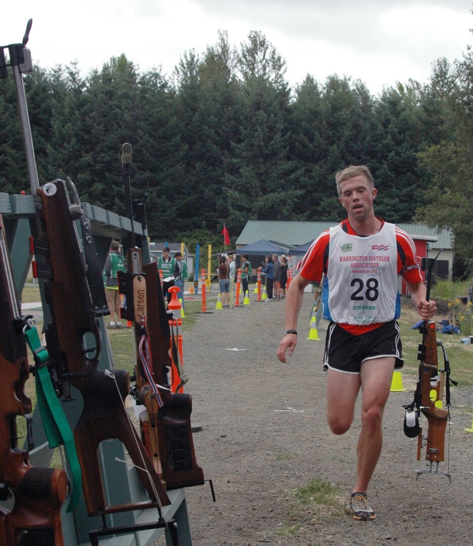 Pfc. Mike Scharn of the South Dakota Guard's 200th Engineer Company leaves the range during the 2010 Summer Biathlon National Championships in Tukwila, Wash., Aug. 19, 2010. He was the winner of the pursuit race in the junior men's division. Running while one hand is on the barrel of the rifle is allowable in summer biathlon.