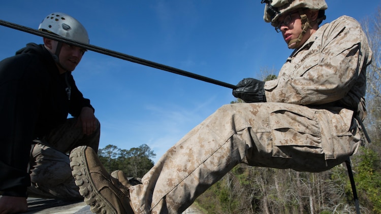 Lance Cpl. Jesse Bradley, an infantryman with Golf Company, 2nd Battalion, 2nd Marine Regiment, prepares to maneuver down the rappel tower aboard Camp Lejeune, North Carolina, April 2, 2015. The rappel tower was part of a week-long field exercise for Golf Company, which also included land navigation and grenade throwing.