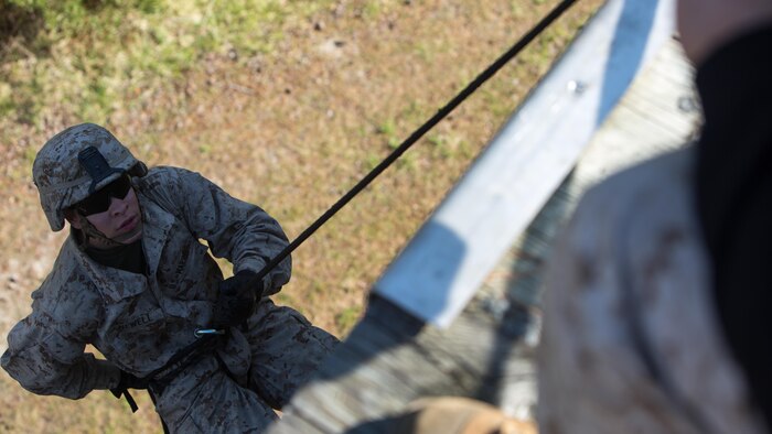 Private First Class Tre Newell, an infantryman with Golf Company, 2nd Battalion, 2nd Marine Regiment, rappels off the rappel tower aboard Camp Lejeune, North Carolina, April 2, 2015. Each rappel station had a trained helicopter rope suspension techniques master, who instructed the Marines how to properly maneuver down the wall. Marines were positioned at the bottom to brake the Marines rappelling if necessary.