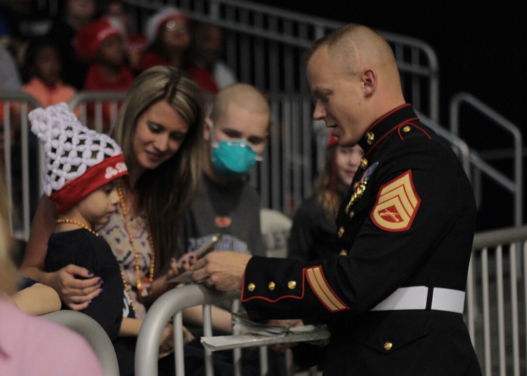 Staff Sgt. Shawn W. Freeman, an officer selection assistant with Recruiting Station Indianapolis, handed out stickers and spoke with fans at the State Farm College Slam Dunk and 3-Point Championship at Butler University, April 2, 2015. Photo by Sgt. Tyler S. Mitchell
