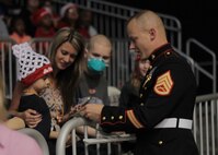 Staff Sgt. Shawn W. Freeman, an officer selection assistant with Recruiting Station Indianapolis, handed out stickers and spoke with fans at the State Farm College Slam Dunk and 3-Point Championship at Butler University, April 2, 2015. Photo by Sgt. Tyler S. Mitchell