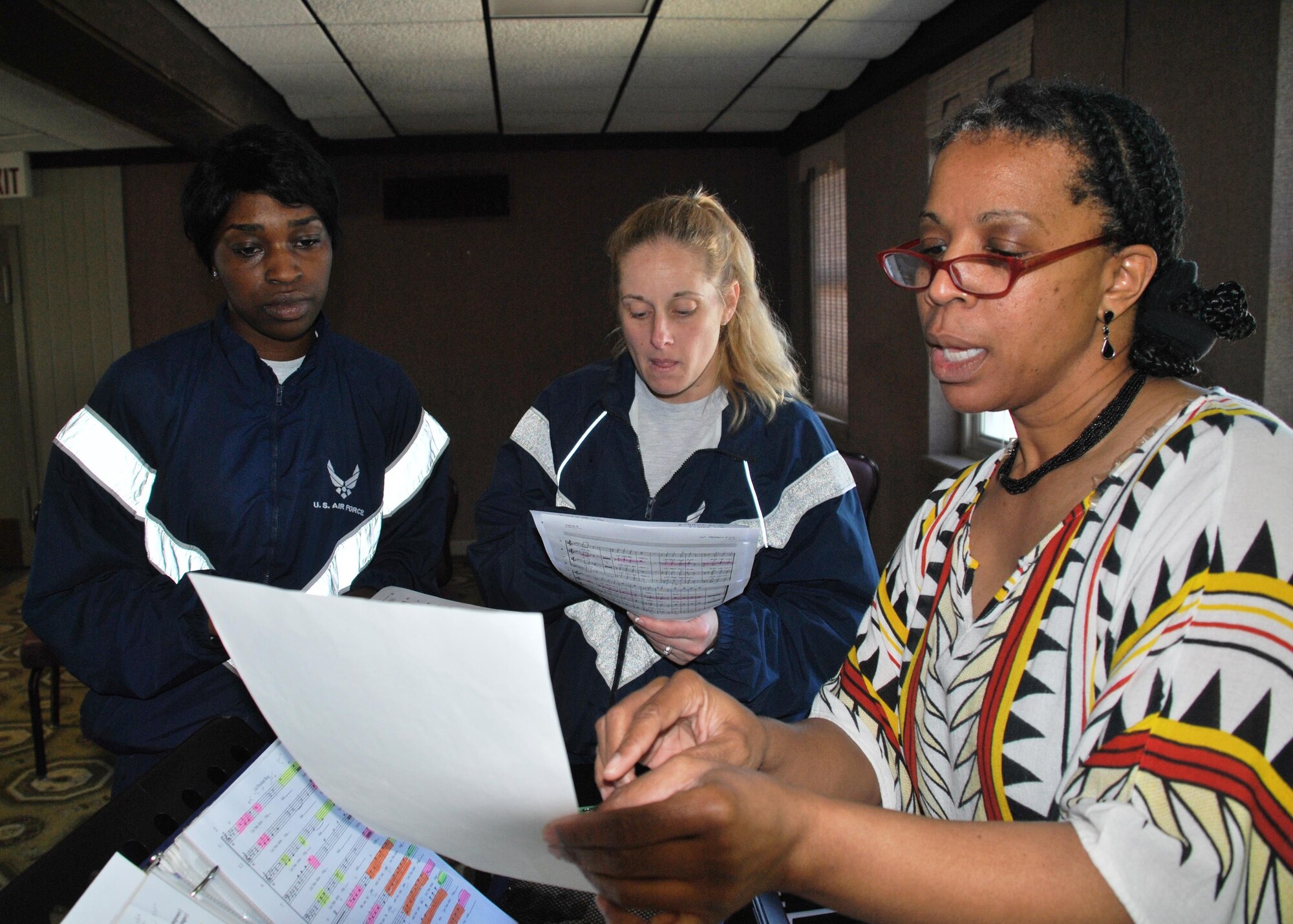 From left, Staff Sgt. Kennesha Key and Staff Sgt. Heather Slade receive pointers from Tops In Blue Vocal Coach Sarah Cantrell during a training session March 27 at the Kelly Club, Joint Base San Antonio-Lackland, Texas. Following a morning of 