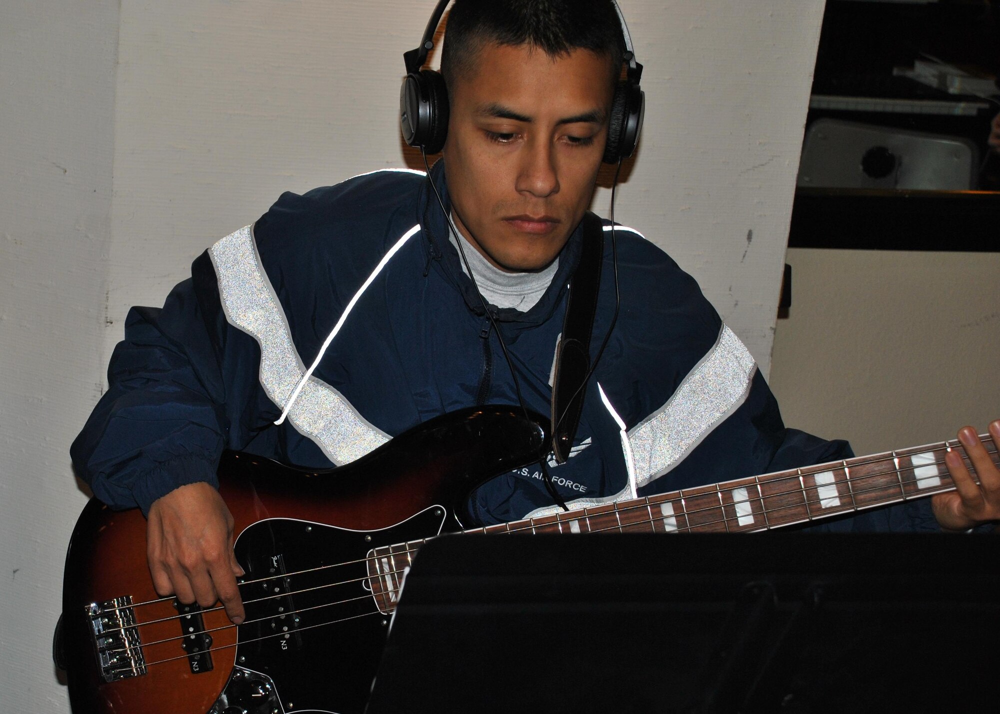 Senior Airman Kenny Casaverde plays bass guitar during a training session March 27 at the Kelly Club, Joint Base San Antonio-Lackland. Casaverde and the other members of the 2015 Tops In Blue team will hit the road in May to entertain military members, their families and civilian communities around the world. (U.S. Air Force photo/Debbie Aragon/Released)