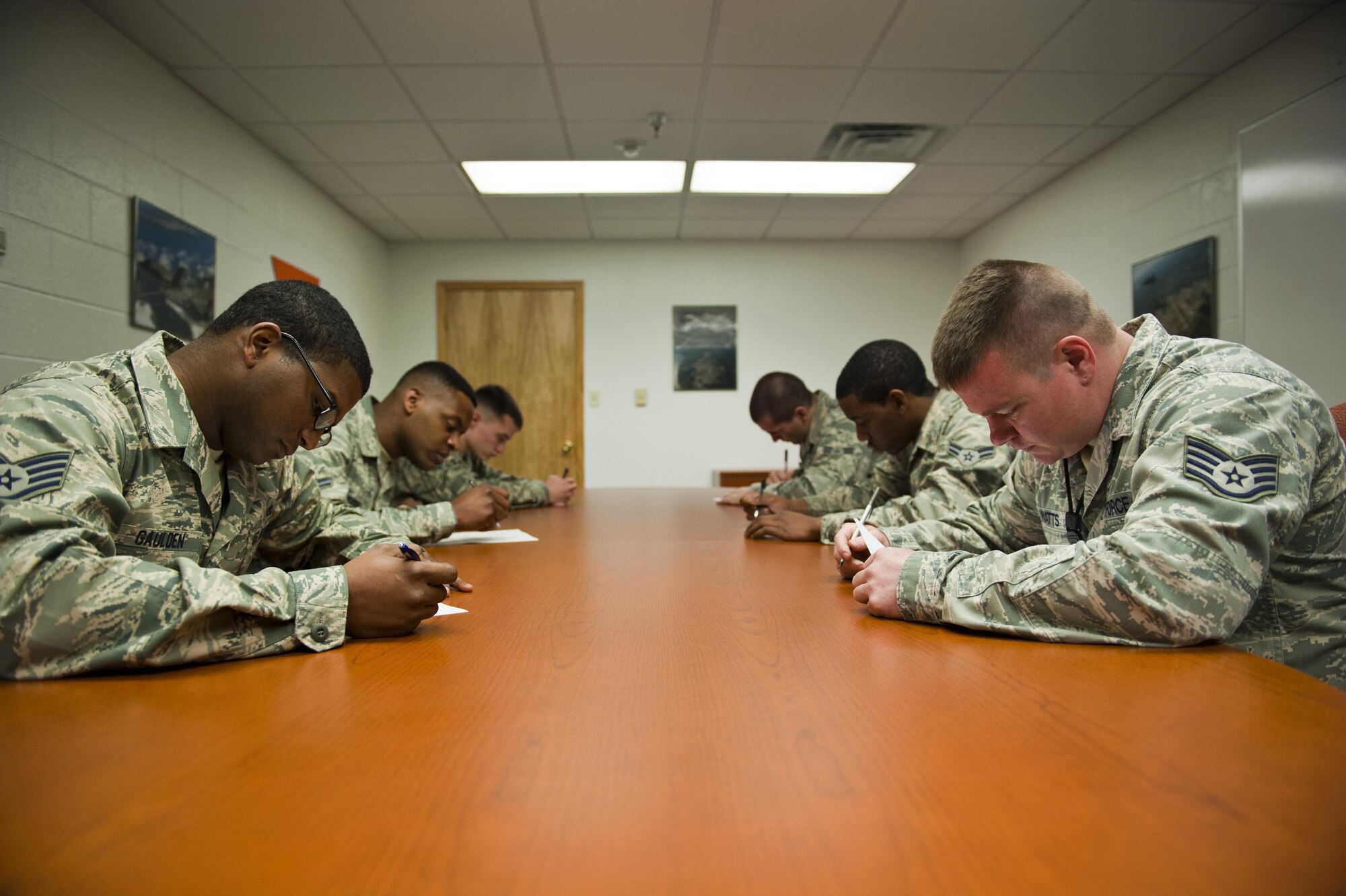 Members with the 58th Aircraft Maintenance Unit’s crew one and crew six take a written test as part of a weapons load competition on Eglin Air Force Base, Florida, April 3, 2015. A uniform inspection and a quality assurance inspection of the teams’ tool kits was also considered in the score for each crew during the competition. This was the 33rd Fighter Wing’s first weapons load competition that determined the best F-35A Lightning II weapons load crew. (U.S. Air Force Photo/Staff Sgt. Marleah Robertson)
