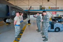 Staff Sgt. Nicholas Egebrecht, 33rd Maintenance Group weapons standardization squadron lead crew chief, briefs crew one before a weapons load competition on Eglin Air Force Base, Florida, April 3, 2015. This is the 33rd Fighter Wing’s first weapons load competition since the 2009 draw down of the F-15C Eagle mission and determined the best F-35A Lightning II weapons load crew here. (U.S. Air Force Photo/Staff Sgt. Marleah Robertson)