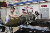 Airman 1st Class Reece Zoller, left, 58th Aircraft Maintenance Unit crew one load crew member, and Staff Sgt. Zachary Watts, right, 58 AMU crew one load crew chief, prepare to load a GBU-31 Joint Direct Attack Munition on to an F-35A Lightning II during a weapons load competition on Eglin Air Force Base, Florida, April 3, 2015. This was the 33rd Fighter Wing’s first weapons load competition since the 2009 draw down of the F-15C Eagle mission and it determined the best F-35A Lightning II weapons load crew. (U.S. Air Force Photo/Staff Sgt. Marleah Robertson)