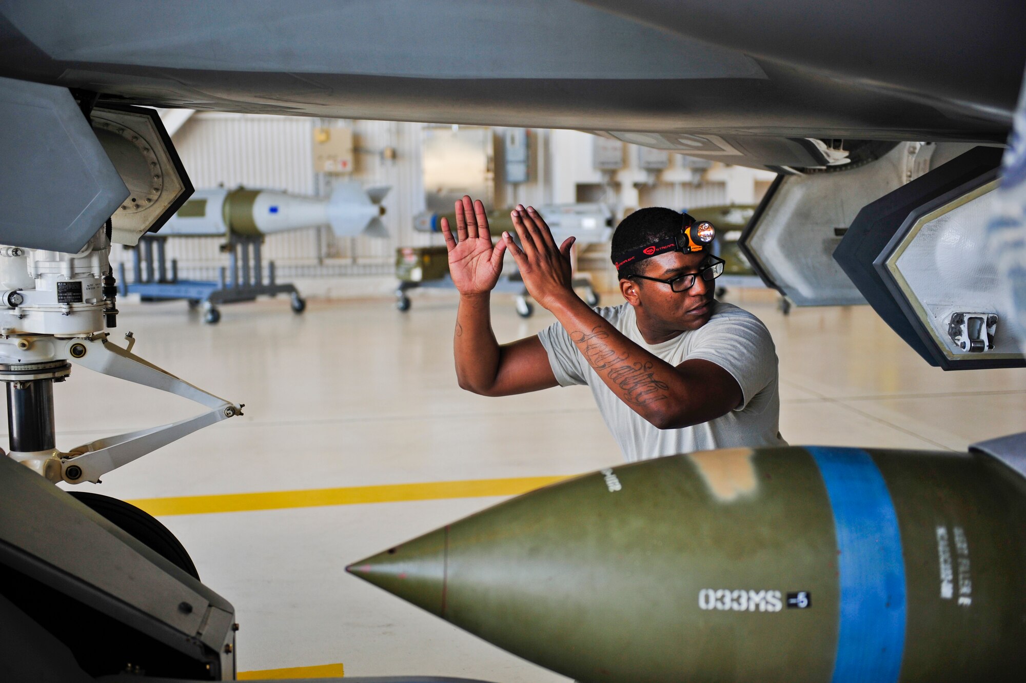 Staff Sgt. Timothy Gaulden, 58th Aircraft Maintenance Unit crew one load crew chief, guides a GBU-31 Joint Direct Attack Munition on to an F-35A Lightning II during a weapons load competition on Eglin Air Force Base, Florida, April 3, 2015. Gaulden and his team, Airmen 1st Class John St. Cyr and Jake Wiedmeyer, load crew members, earned the title as best load crew in the 33 FW. (U.S. Air Force Photo/Staff Sgt. Marleah Robertson)