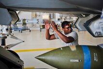 Staff Sgt. Timothy Gaulden, 58th Aircraft Maintenance Unit crew one load crew chief, guides a GBU-31 Joint Direct Attack Munition on to an F-35A Lightning II during a weapons load competition on Eglin Air Force Base, Florida, April 3, 2015. Gaulden and his team, Airmen 1st Class John St. Cyr and Jake Wiedmeyer, load crew members, earned the title as best load crew in the 33 FW. (U.S. Air Force Photo/Staff Sgt. Marleah Robertson)