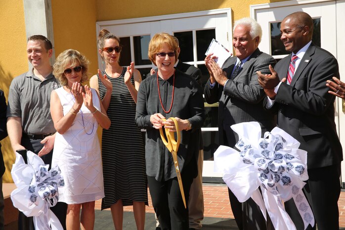Maggie Coleman cuts a ribbon to signifying the dedication of Marine Corps Recruit Depot San Diego field house to her late husband April 3. The Jerry Coleman Center is lined with photos and murals depicting the life of Coleman as well as an original painting of Coleman created by a former Marine production specialist and artist. 