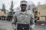 New Jersey Army National Guard Pfc. Nathaniel Okyere-Bour stands at the Morristown Armory with his acceptance letter from the U.S. Military Academy at West Point, New York, March 27, 2015. Okyere-Bour is a wheeled-vehicle maintenance specialist from the 250th Brigade Support Battalion, and is currently a student at Rutgers University. He was one of 25 Army National Guard soldiers to be accepted into West Point this year. 