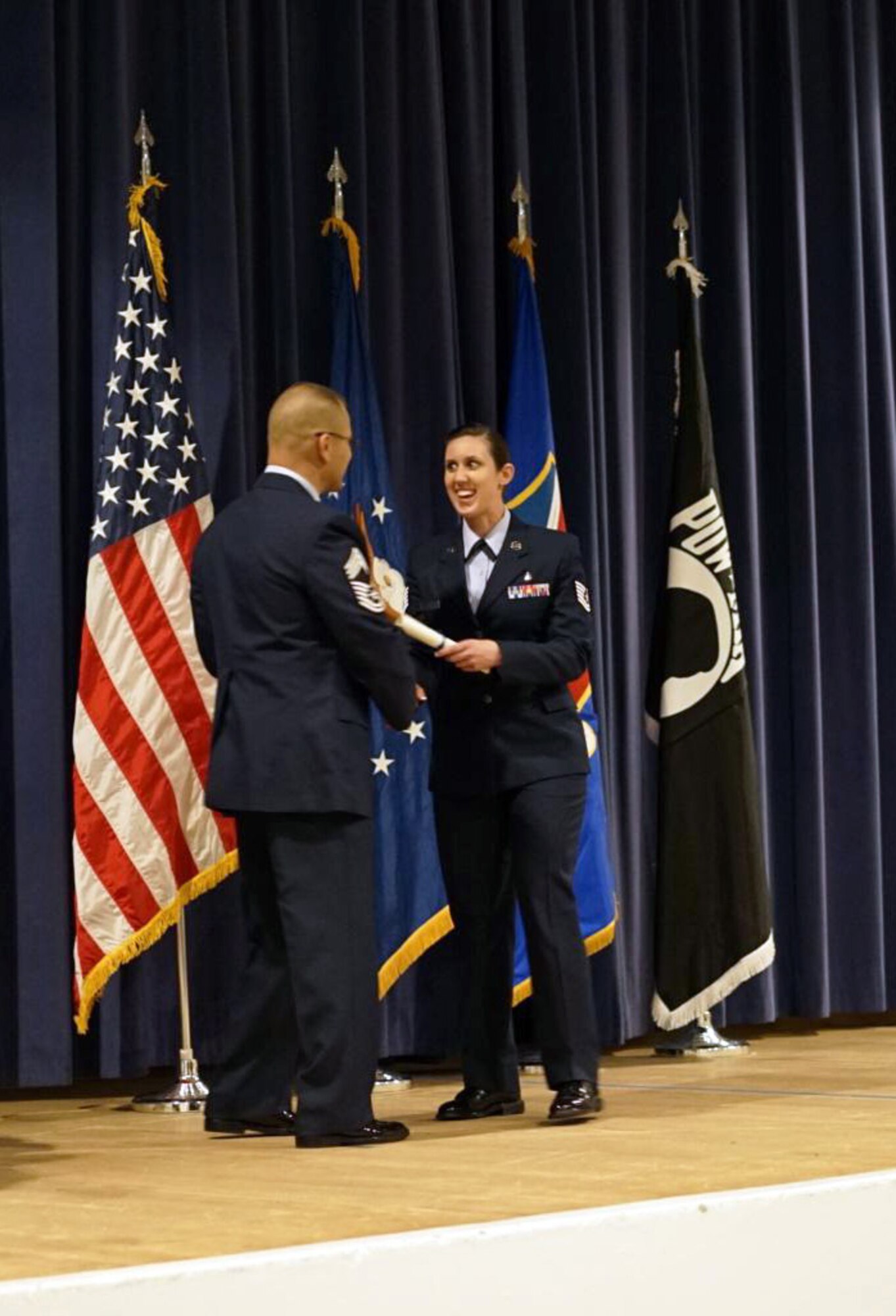 Tech Sgt. Pamela Torrez, Air Reserve Personnel Center education services technician, is congratulated by Chief Master Sgt. Todd Krulcik, Vosler NCO Academy commandant, upon her graduation from the Forrest L. Vosler NCO Academy Class 15-3 March 27, 2015, at Peterson Air Force Base, Colorado. (U.S. Air Force courtesy photo)