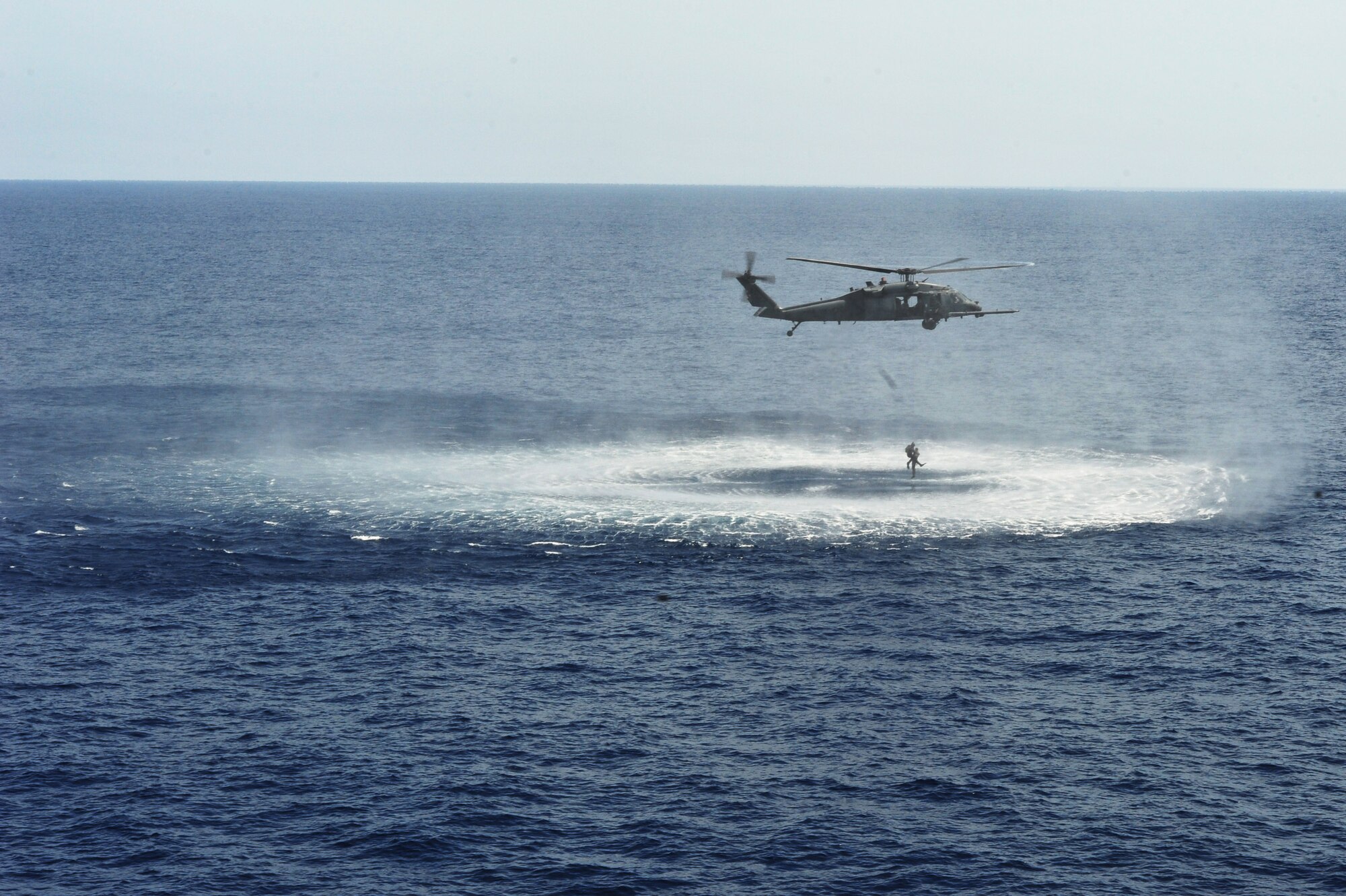 An HH-60G Pave Hawk assigned to the 33rd Rescue Squadron drops off two pararescuemen during the Forceful Tiger exercise over the Pacific Ocean, April 1, 2015. The pararescuemen simulated downed pilots and allowed the 33rd RQS to practice combat search and rescue techniques in a hostile environment. The parescuemen are assigned to the 31st Rescue Squadron. (U.S. Air Force photo by Staff Sgt. Rachelle Coleman)