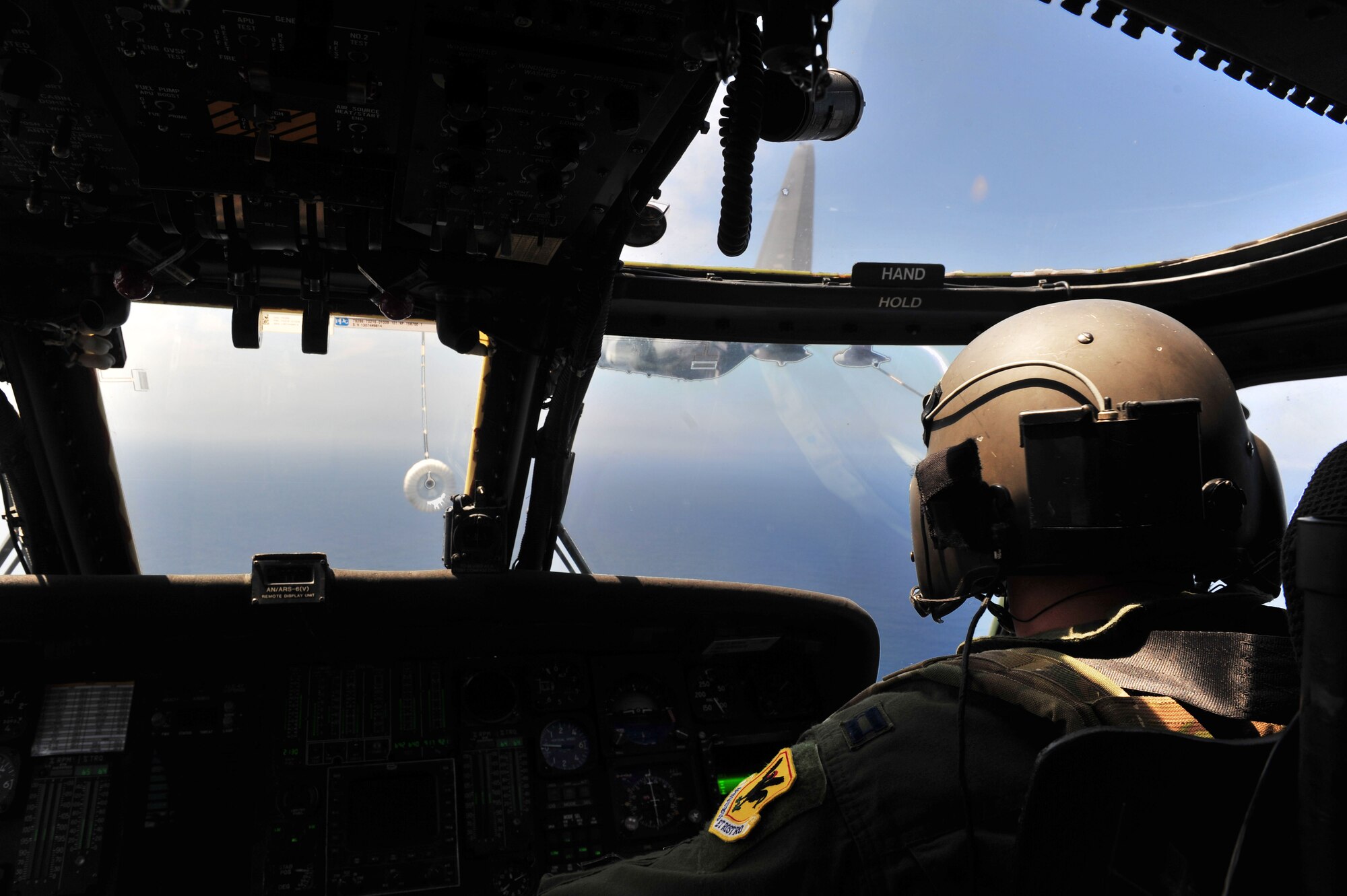 U.S. Air Force Capt. Alexander Sira, 33rd Rescue Squadron rescue pilot, maneuvers an HH-60G Pave Hawk to receive fuel from an MC-130P Combat Shadow during the Forceful Tiger exercise over the Pacific Ocean, April 1, 2015. The exercise allowed the 33rd RQS to practice combat search and rescue techniques in a hostile environment. The Combat Shadow is assigned to the 17th Special Operations Squadron and the Pave Hawk is assigned to the 33rd RQS. (U.S. Air Force photo by Staff Sgt. Rachelle Coleman)   