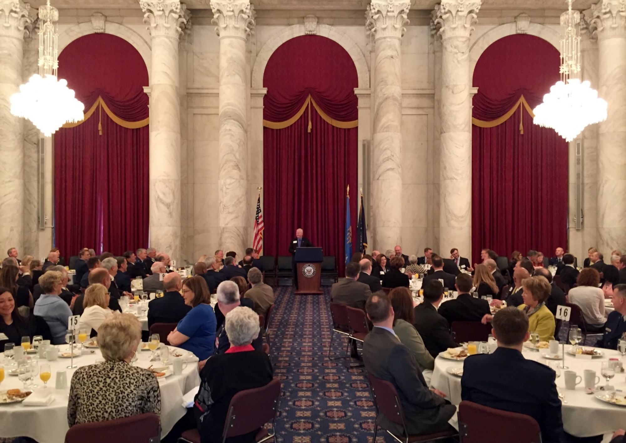 Washington -- Dr. Joe Leverett, Chairman of the Altus Military Affairs Committee, speaks to the audience during the 53rd Annual Altus Quail Breakfast in the Russell Senate Office Building, Kennedy Caucus Room, March 26, 2015. The quail breakfast is an annual event that celebrates the unique relationship between the Oklahoma Delegation, the City of Altus and the U.S. Air Force. (U.S. Air Force photo by Senior Airman Robert Gunn/Released)