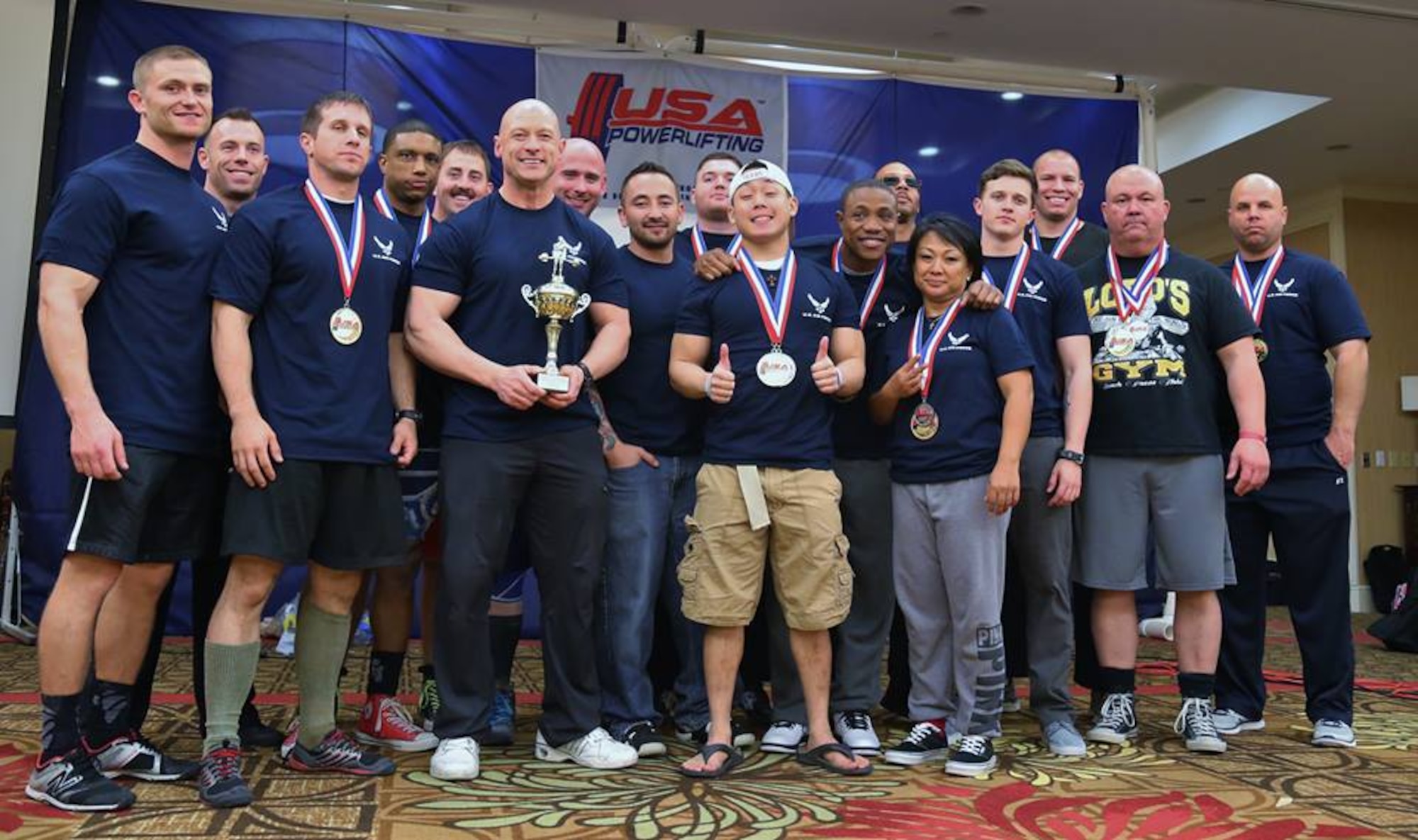 The Air Force Powerlifting Team is shown at the 2015 USAPL Military Nationals and Southeastern State Bench Competition in Atlanta March 14, 2015. Master Sgt. Michael D. Lear, 347th Recruiting Squadron, is at far left, and Tech. Sgt. Michael L. Parrott, Headquarters Air Force Recruiting Service, is fourth from left. Holding the team’s silver trophy is the coach, Chief Master Sgt. Troy Saunders, HQ Air Force, the Pentagon. (Courtesy photo)