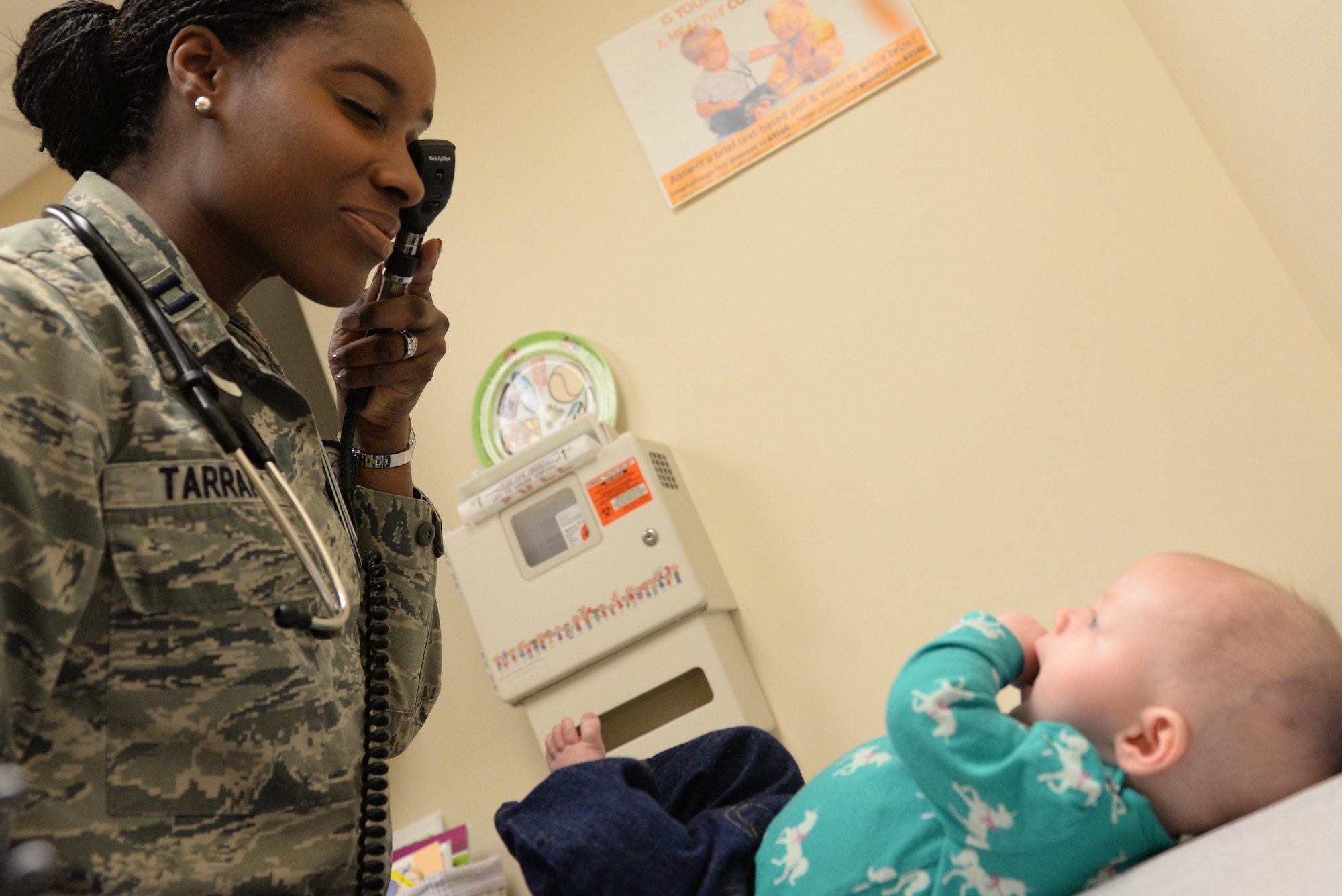 Capt. Chauncey Tarrant, 375th Medical Operations Squadron General Pediatrician, examines a patient at the 375th Medical Group at Scott Air Force Base, Illinois, April 1, 2015. Tarrant, along with four other pediatricians, takes care of the health needs of military children at Scott. (U.S. Air Force photo by Senior Airman Sarah Hall-Kirchner/Released)