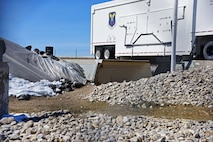A 100-ton launcher closure door sits still after being propelled open from a missile launch facility and slamming into a 12-foot-high berm during a Simulated Electronic Launch-Minuteman test April 7 near Malmstrom Air Force Base, Mont. Coupled with Minuteman missile launches from Vandenberg AFB, California, the data gathered from these tests provides leaders throughout Air Force Global Strike Command with invaluable information on how these systems will work in a real-life scenario. (U.S. Air Force/Airman 1st Class Collin Schmidt)