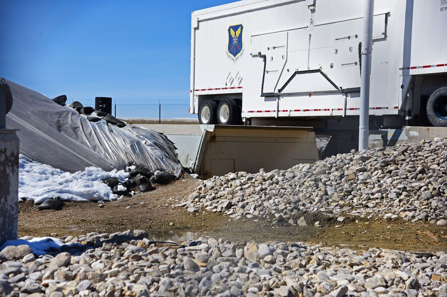 A 100-ton launcher closure door sits still after being propelled open from a missile launch facility and slamming into a 12-foot-high berm during a Simulated Electronic Launch-Minuteman test April 7 near Malmstrom Air Force Base, Mont. Coupled with Minuteman missile launches from Vandenberg AFB, California, the data gathered from these tests provides leaders throughout Air Force Global Strike Command with invaluable information on how these systems will work in a real-life scenario. (U.S. Air Force/Airman 1st Class Collin Schmidt)