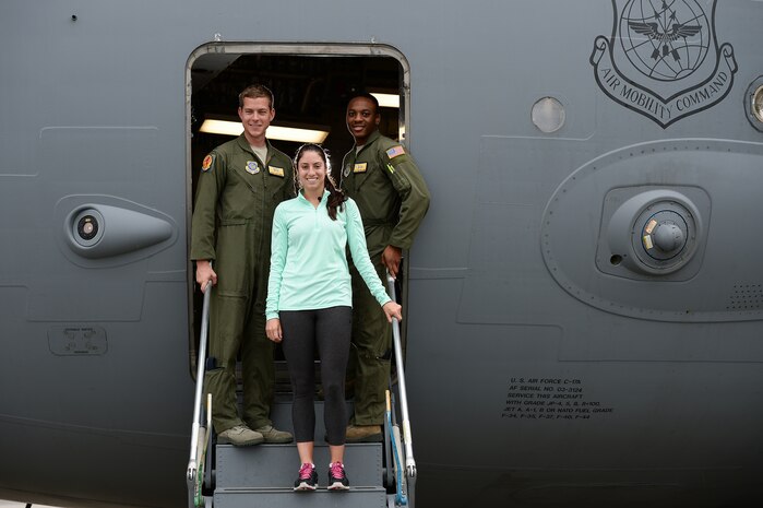 Professional women’s tennis player Christina McHale poses for a photo with 1st Lt. Cory Williams and Senior Airman Trae Williams during her tour of Joint Base Charleston, April 7, 2015. McHale is in Charleston as a participant in the Family Circle Cup tournament. Lt. Williams and Airman Williams are both part of the 16th Airlift Squadron. (Courtesy Photo/Chris Smith)