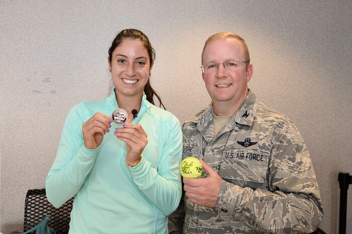 Professional women’s tennis player Christina McHale shows off a coin presented by Col. Jeffrey Devore during her tour of Joint Base Charleston, April 7, 2015. McHale is in Charleston to participate in the Family Circle Cup tournament. Devore is the Joint Base Charleston commander. (Courtesy Photo/Chris Smith)