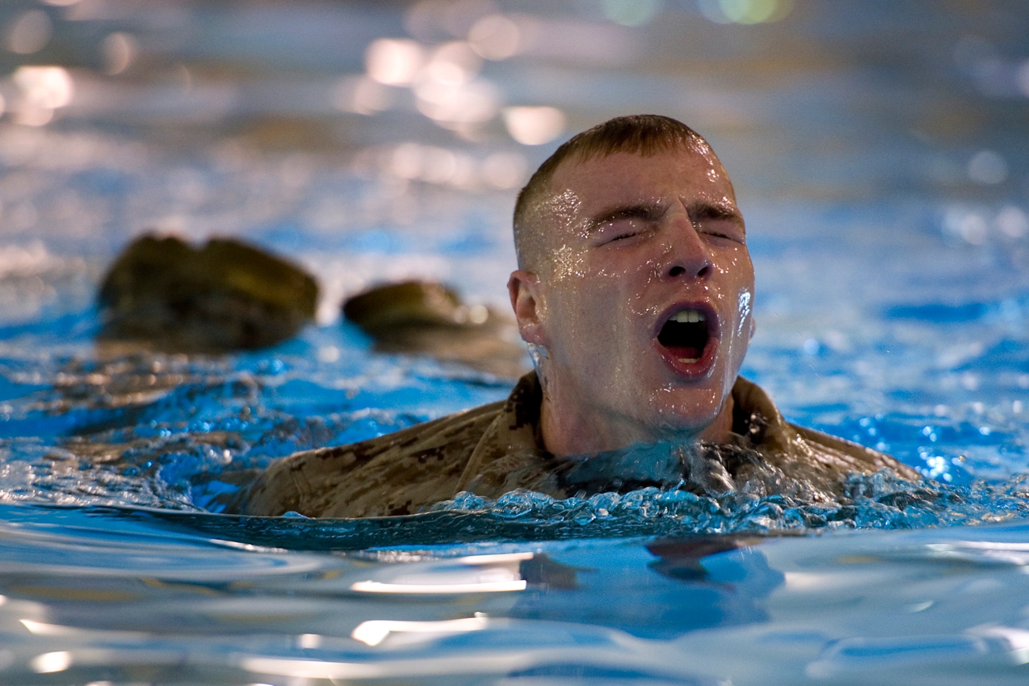 A Marine from Detachment 1, Communication Company, Combat Logistics Regiment 45, 4th Marine Logistics Group, comes up for air during the Marine Corps water survival training program intermediate qualification at Great Lakes Naval Station, Ill., March 21, 2015. During training approximately 90 Marines completed basic qualification with a 100 percent pass rate and another 25 volunteers went on to complete intermediate qualification. (U.S. Air Force photo/Tech. Sgt. Benjamin Mota)