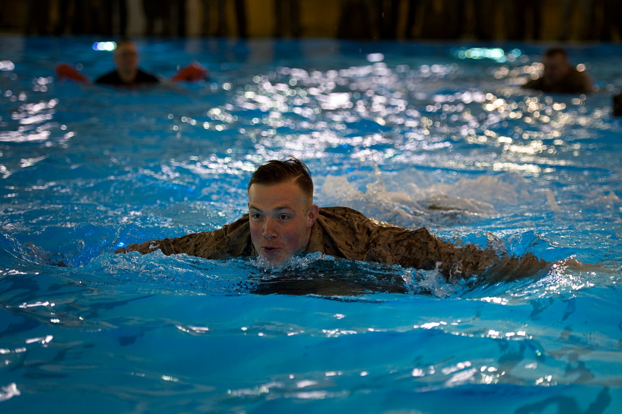 U.S. Marine Corps Lance Cpl. Jacob Lambert, Detachment 1, Communication Company, Combat Logistics Regiment 45, 4th Marine Logistics Group radio operator, uses his pack to help him swim during the 25-meter pack-swim portion of the Marine Corps water survival training program basic qualification at Great Lakes Naval Station, Ill., March 21, 2015.  Marines are required to complete basic level of qualifications every two years and can progress to advanced levels of training on a voluntary basis. (U.S. Air Force photo/Tech. Sgt. Benjamin Mota)