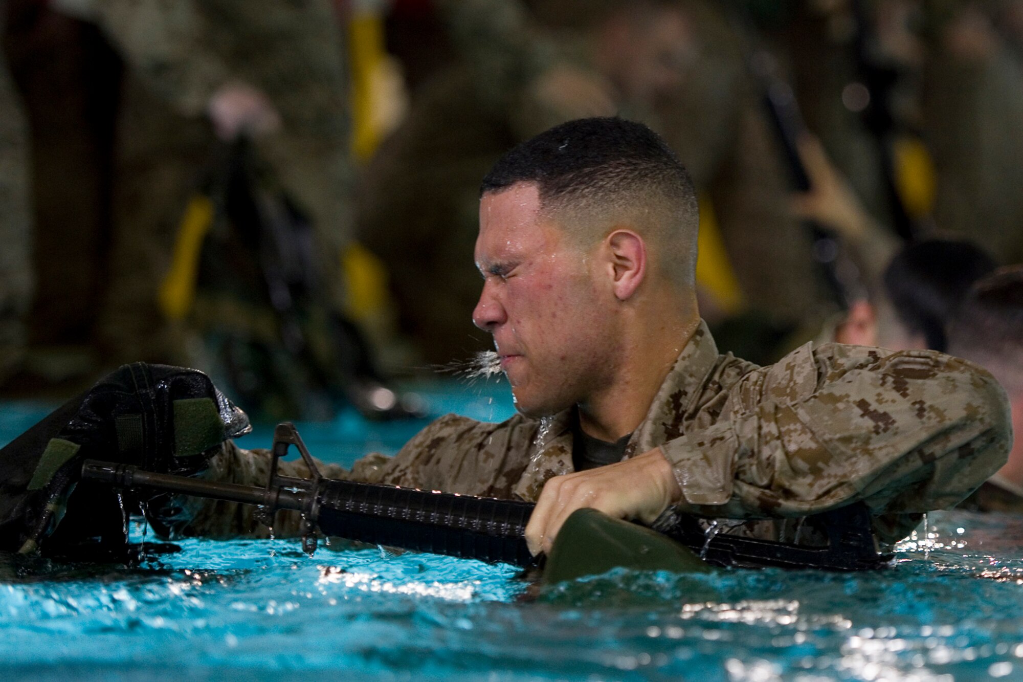 A Marine from Detachment 1, Communication Company, Combat Logistics Regiment 45, 4th Marine Logistics Group, comes up for air after removing his combat gear during the Marine Corps water survival training program basic qualification at Great Lakes Naval Station, Ill., March 21, 2015. During training approximately 90 Marines completed basic qualification with a 100 percent pass rate and another 25 volunteers went on to complete intermediate qualification. (U.S. Air Force photo/Tech. Sgt. Benjamin Mota)