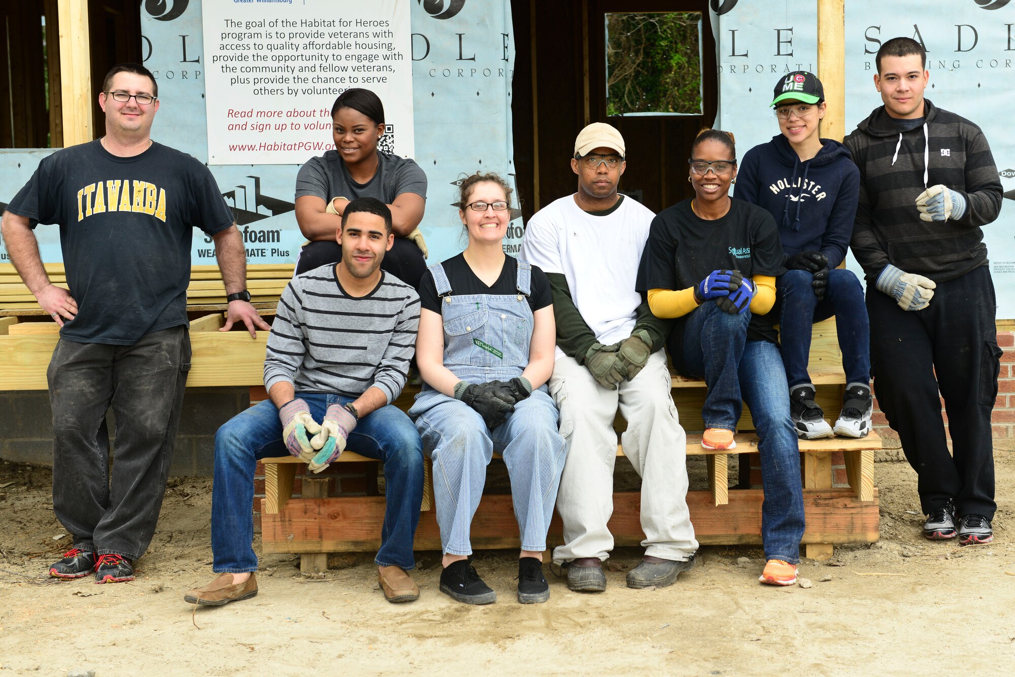 U.S. Army Soldiers from the 99th Transportation Detachment Movement Control Team, 53rd Movement Control Battalion, 7th Transportation Brigade (Expeditionary) pose for a photo in front of a house in Hampton, Va., April 4, 2015.  The Soldiers assisted with cleaning up unused construction equipment around two houses while volunteering with the Habitat for Humanity Peninsula and Greater Williamsburg Habitat for Heroes program. (U.S. Air Force photo by Senior Airman Kimberly Nagle/Released)