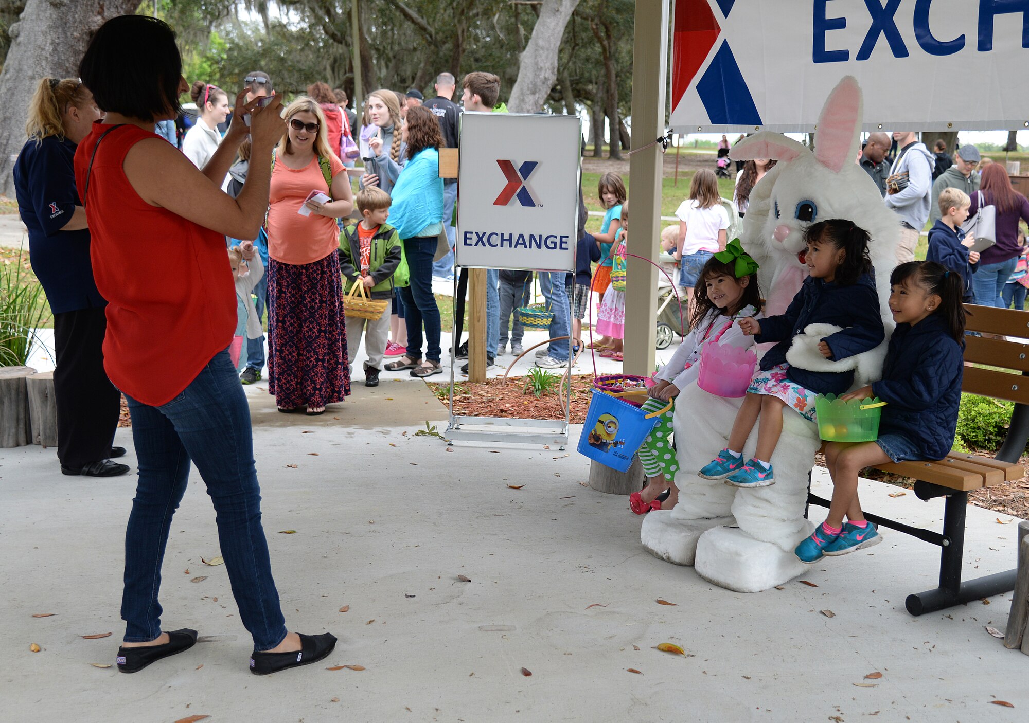 Families take photos with the Easter bunny at the 2015 Child Pride Day, April 4, 2015, at marina park, Keesler Air Force Base, Miss. More than 600 children and parents from Keesler attended the event that featured activities, demonstrations and attendees information on programs focused on care of military families. (U.S. Air Force photo by Senior Airman Holly Mansfield)
