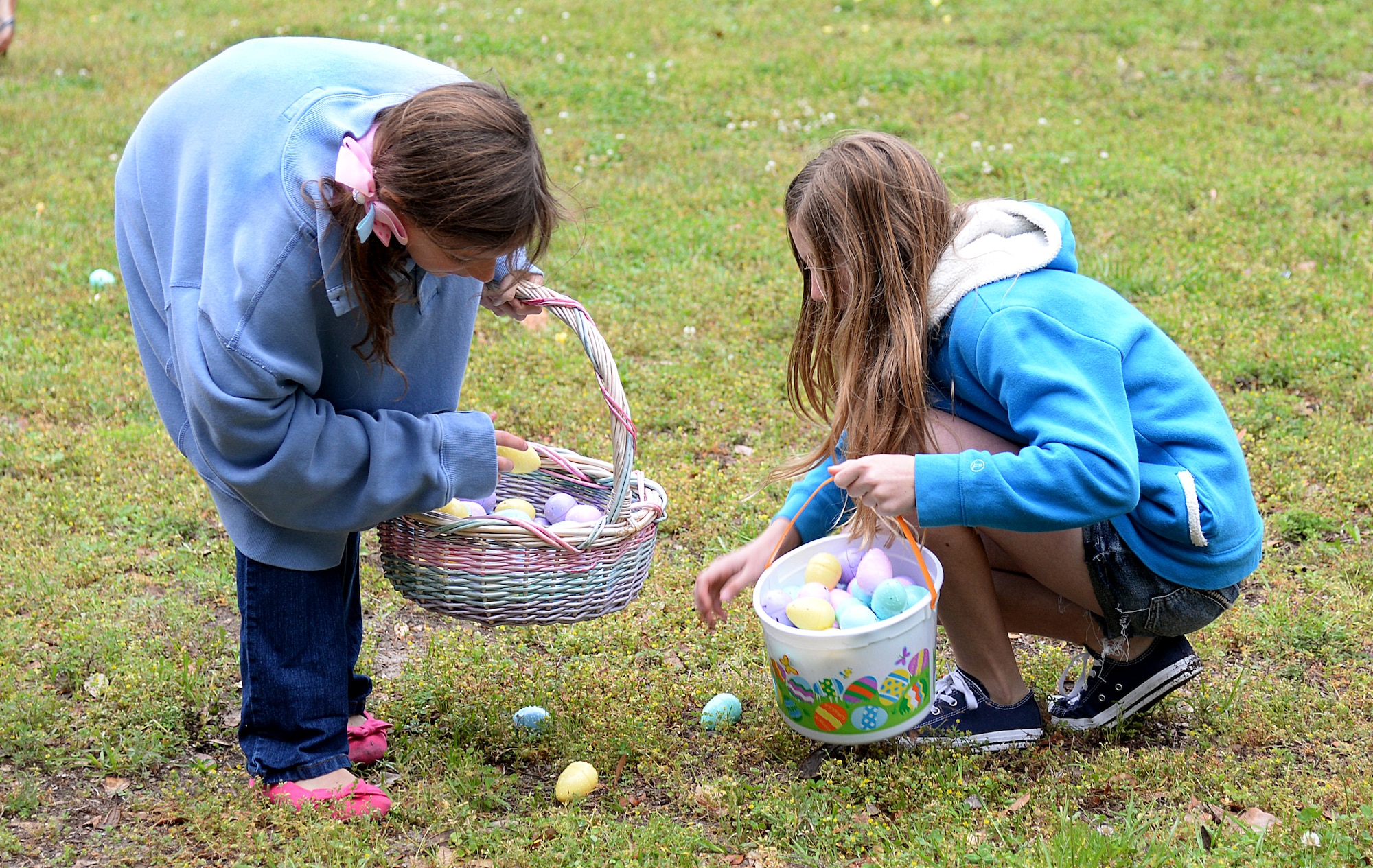 Children participate in an Easter egg hunt at the 2015 Child Pride Day, April 4, 2015, at marina park, Keesler Air Force Base, Miss. More than 600 children and parents from Keesler attended the event that featured activities, demonstrations and attendees with information on programs focused on care of military families. (U.S. Air Force photo by Senior Airman Holly Mansfield)