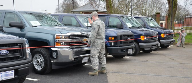 U.S. Air Force Staff Sgt. Ryin Rader, center, 100th Logistics Readiness Squadron NCO in charge of equipment support from Keyser, W.Va., U.S. Air Force Staff Sgt. Jason Prentice, right, 100th Logistics Readiness Squadron NCO in charge of operators, records and licensing from Portland, Ore., prepare vehicles for U.S. Air Forces in Europe Inspector General Office inspectors, March 19, 2015, on RAF Mildenhall, England. The inspection team visited for a Unit Effectiveness Inspection Capstone Event. (U.S. Air Force photo by Gina Randall/released)