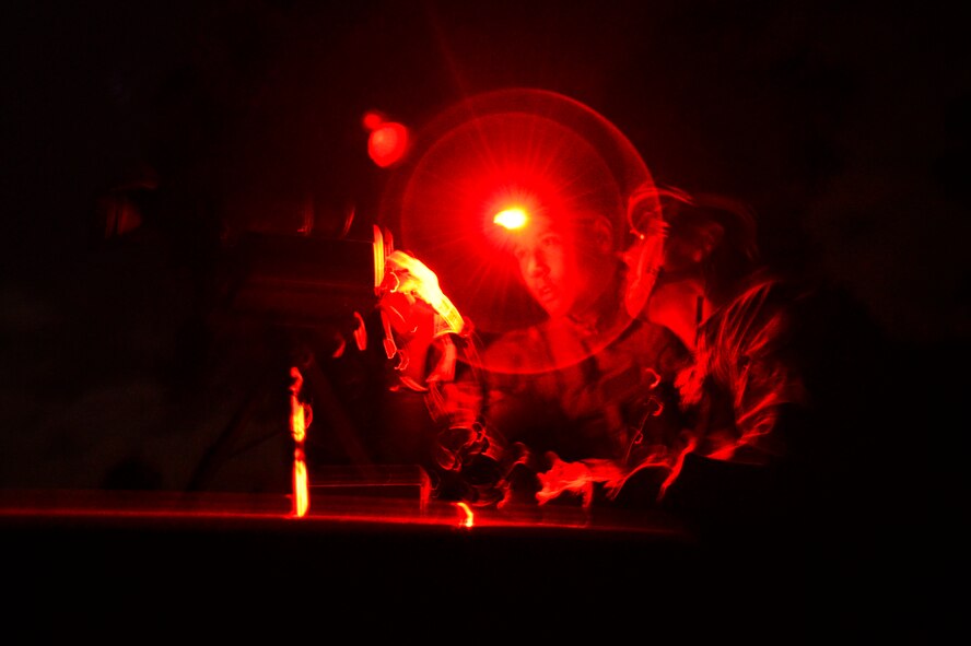 Two Tactical Air Control Party Airmen assigned to the 25th Air Support Operations Squadron, from Wheeler Army Air Field, Hawaii, troubleshoot a Special Operations Forces Laser Acquisition Marker during training at Poinsett Electronic Combat Range, Wedgefield, S.C., March 24, 2015. The SOFLAM is used to mark targets for aircraft identification as well as provide guidance for precision laser guided munitions during ground base laser designation. (U.S. Air Force photo by Senior Airman Diana M. Cossaboom/Released)