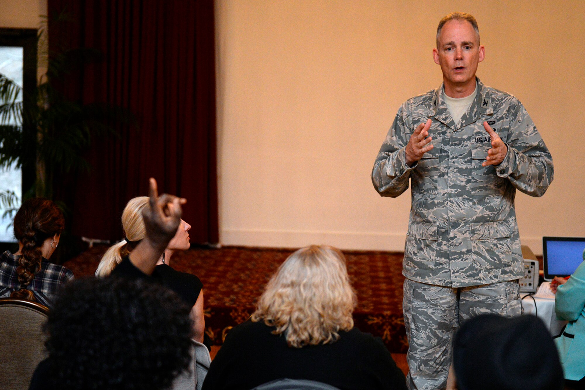 Col. Michael A. Vogel, installation commander, speaks to members of the Hanscom community during a town hall meeting at the Minuteman Commons April 7. Among the topics discussed were traffic safety, civil engineering projects scheduled and base housing, as well as presentations made by the Commissary, Base Exchange and the 66th Force Support Squadron. The town hall was open to those who work or live on Hanscom AFB. (U.S. Air Force photo by Mark Wyatt)