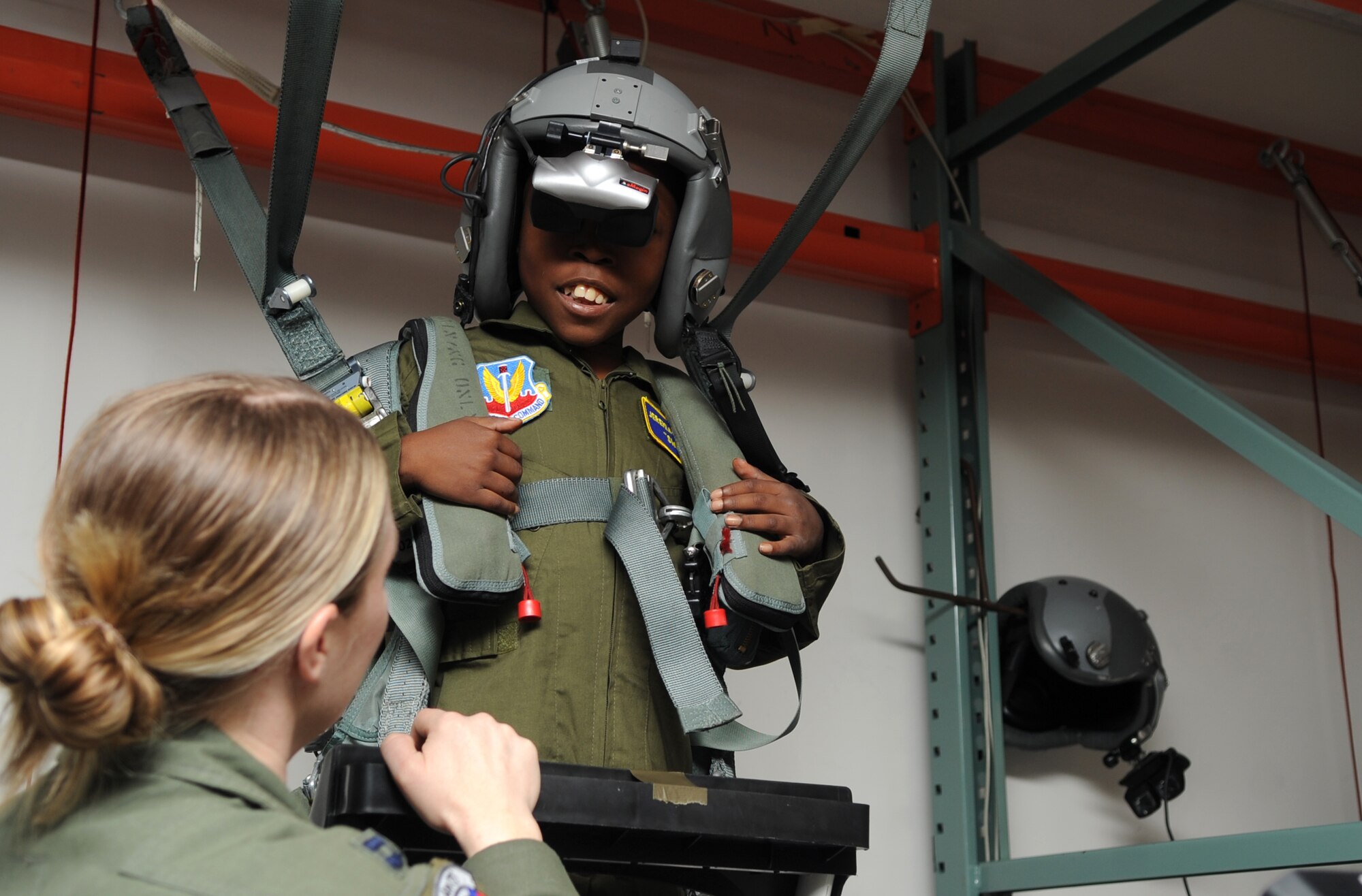 Jeremiah Seaberry, 334th Fighter Squadron pilot for a day, looks to Capt. Kat Frost, PFAD project officer, for help during egress training as part of a 4th Fighter Wing Pilot for a Day event, April 3, 2015, at Seymour Johnson Air Force Base, North Carolina. “Swoosh,” as he was addressed throughout the day, experienced egressing from an aircraft via parachute through virtual reality. (U.S. Air Force photo/Senior Airman Ashley J. Thum)