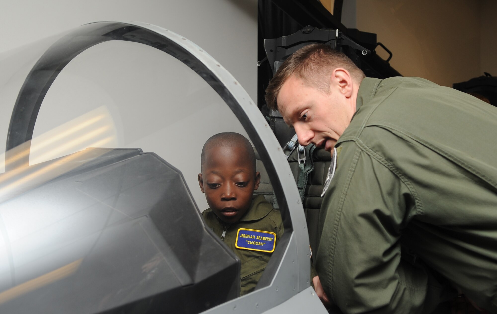 Jeremiah Seaberry, 334th Fighter Squadron pilot for a day, studies an F-15E Strike Eagle egress training cockpit during a 4th Fighter Wing Pilot for a Day event, April 3, 2015, at Seymour Johnson Air Force Base, North Carolina. The base works closely with medical providers in the local community to identify children that can participate in the PFAD program. (U.S. Air Force photo/Senior Airman Ashley J. Thum)
